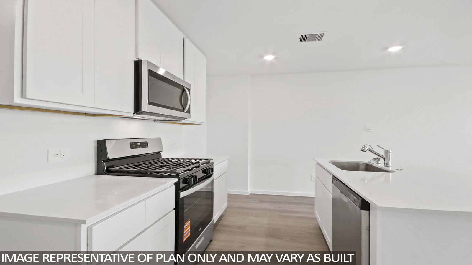 Denise kitchen with kitchen island with light cabinets and light countertops.