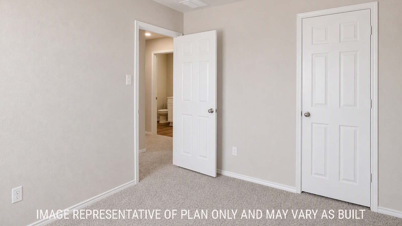 Denise secondary bedroom with carpeted flooring view of hallway to game room.