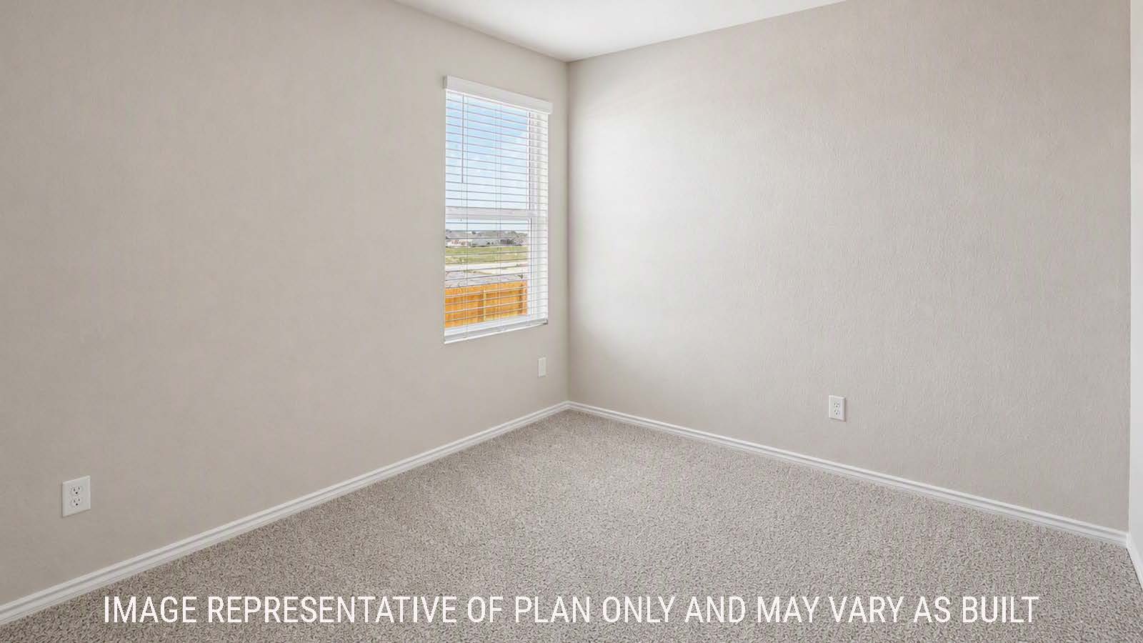 Denise secondary bedroom with carpeted flooring and windows for natural lighting.