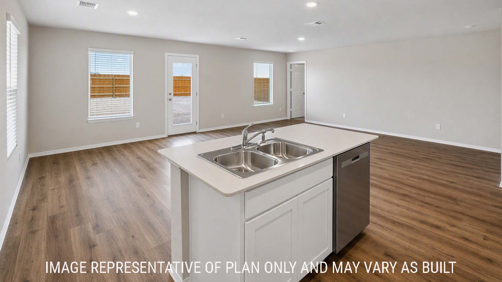 Denise kitchen with kitchen island with view of open concept dining room and living room.