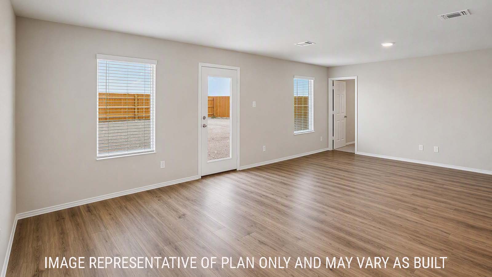 Denise dining room with view of open concept living room  and windows for natural lighting.