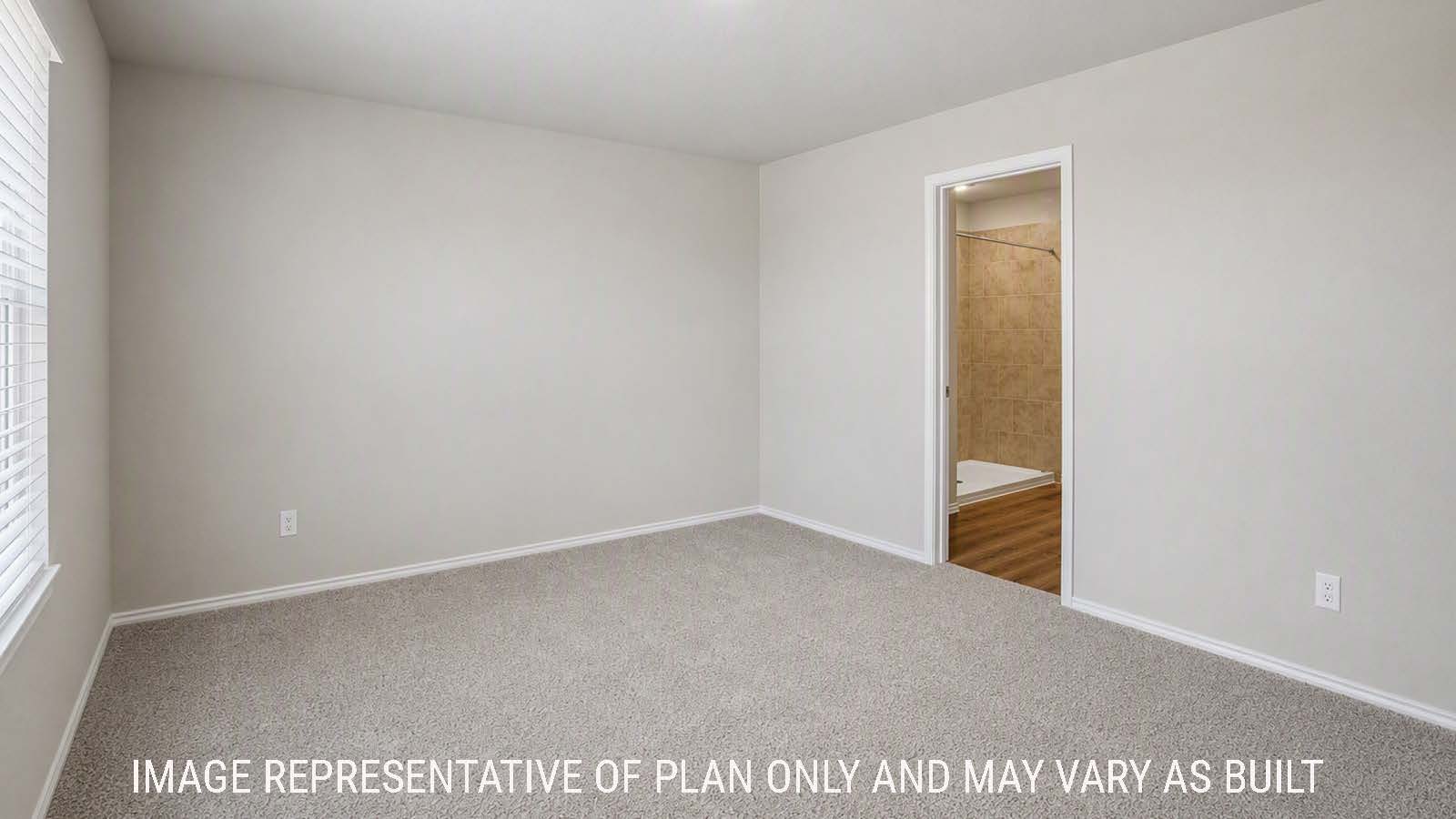 Denise primary bedroom with carpeted flooring and view of primary bathroom.