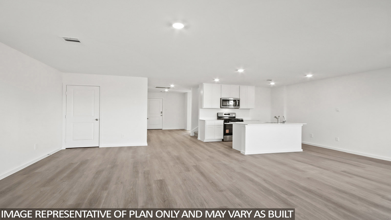 Denise dining room with vinyl plank flooring and view of open-concept living room and kitchen.
