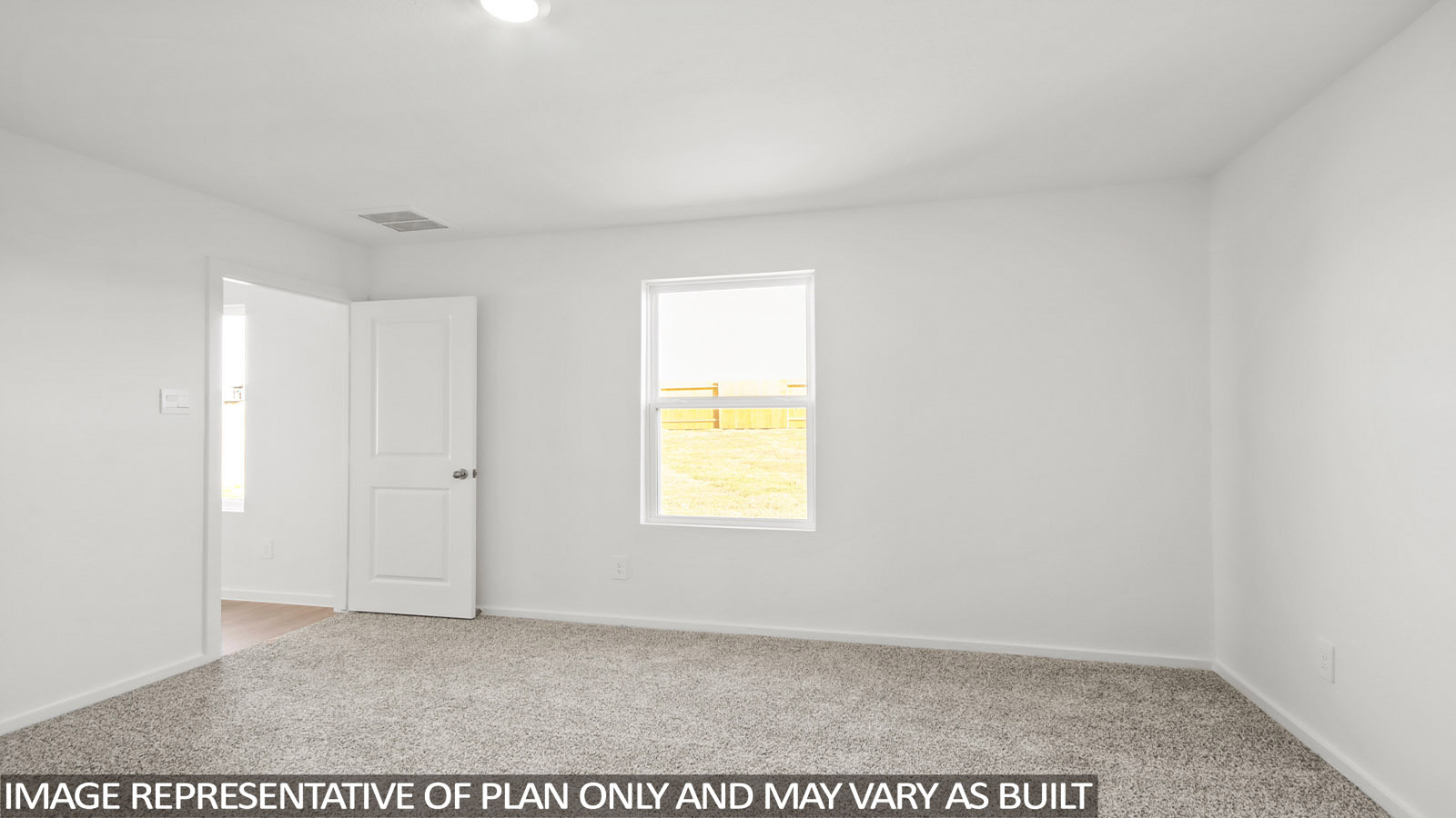 Denise primary bedroom with carpeted flooring and windows for natural lighting.