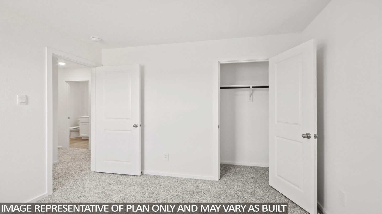 Denise secondary bedroom with carpeted flooring and view of hallway.