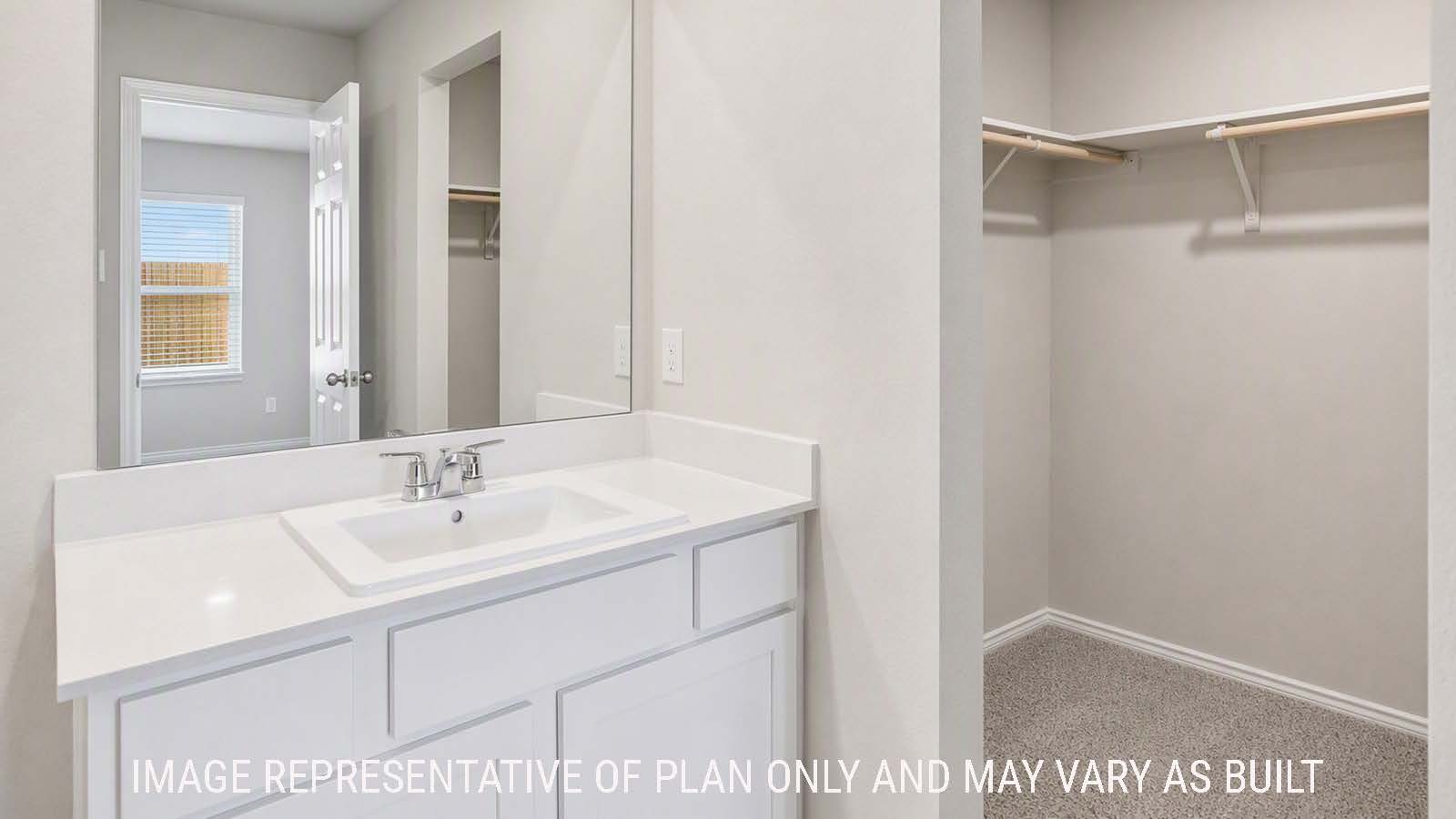 Denise primary bathroom with vanity sink and view of primary bedroom walk-in closet.