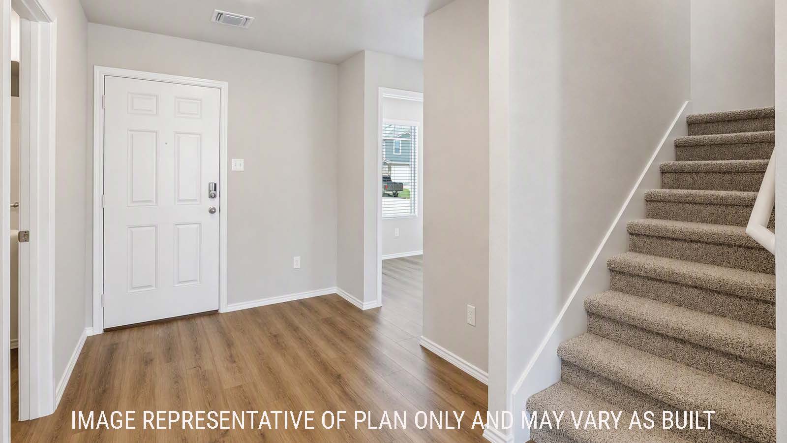 Denise front entry hallway with view of utility room and stairs to the second floor.