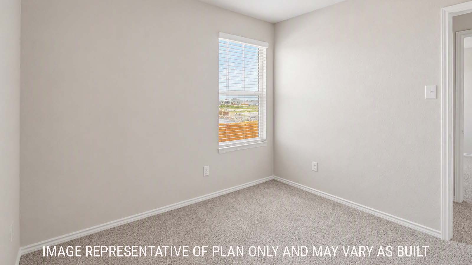 Denise secondary bedroom with carpeted flooring and windows for natural lighting.