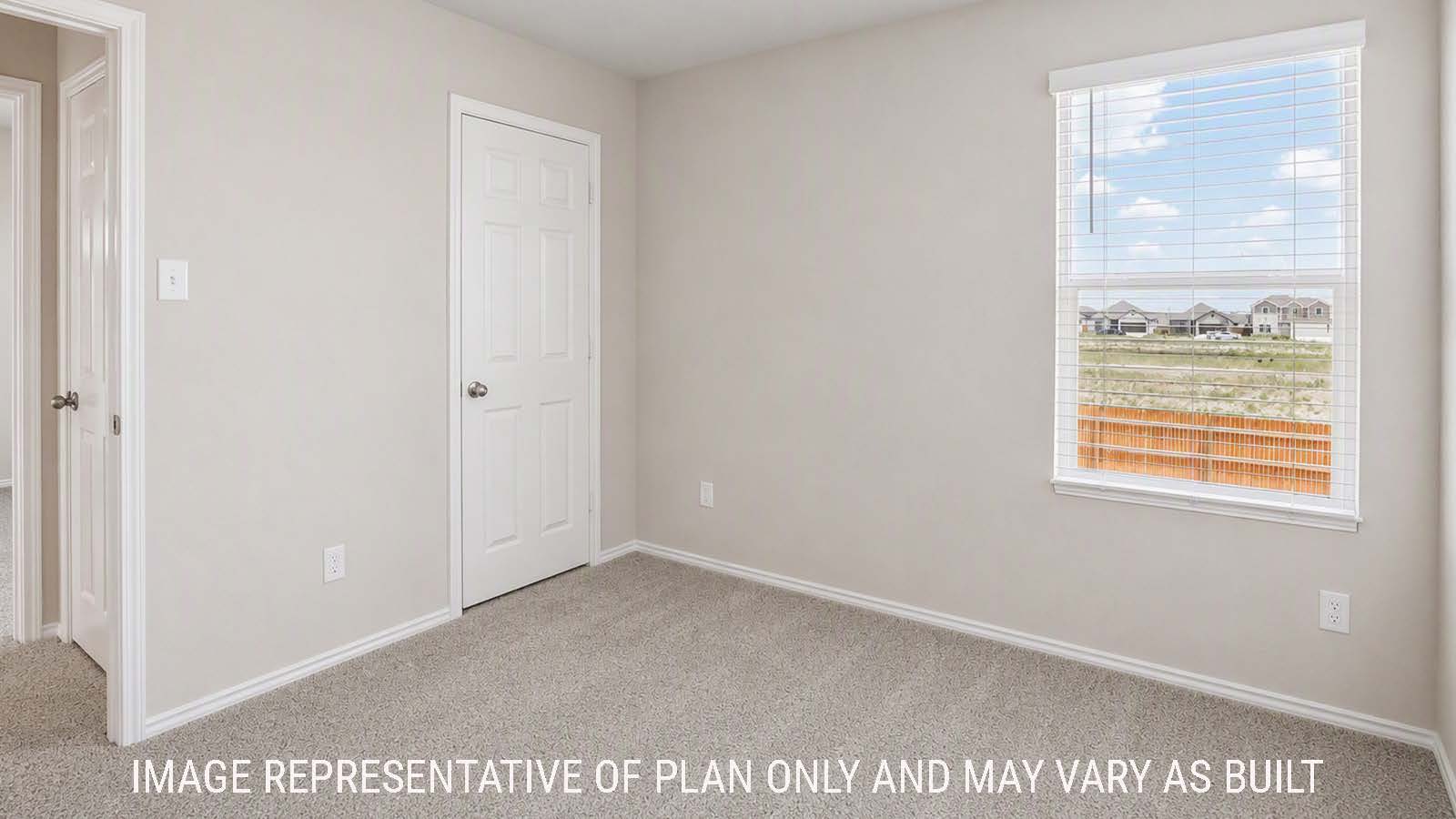 Denise secondary bedroom with carpeted flooring and windows for natural lighting.