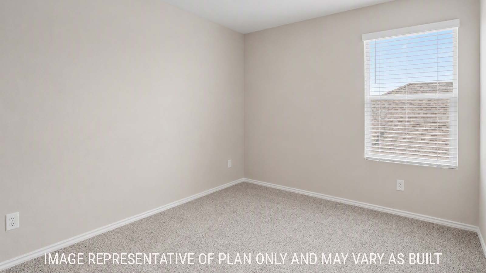 Denise secondary bedroom with carpeted flooring and windows for natural lighting.