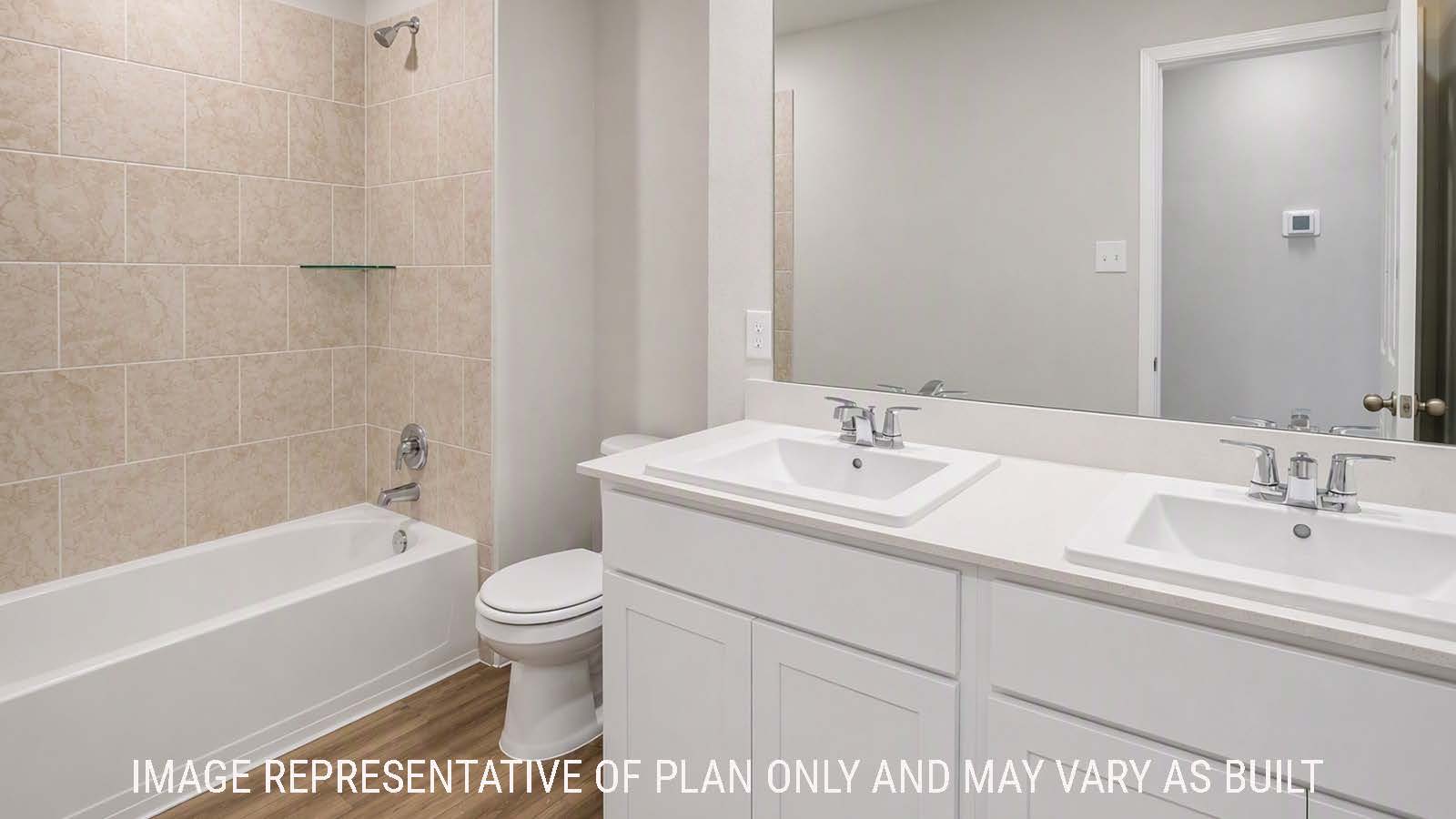 Denise secondary bathroom with double vanity sink and shower and tub combo.