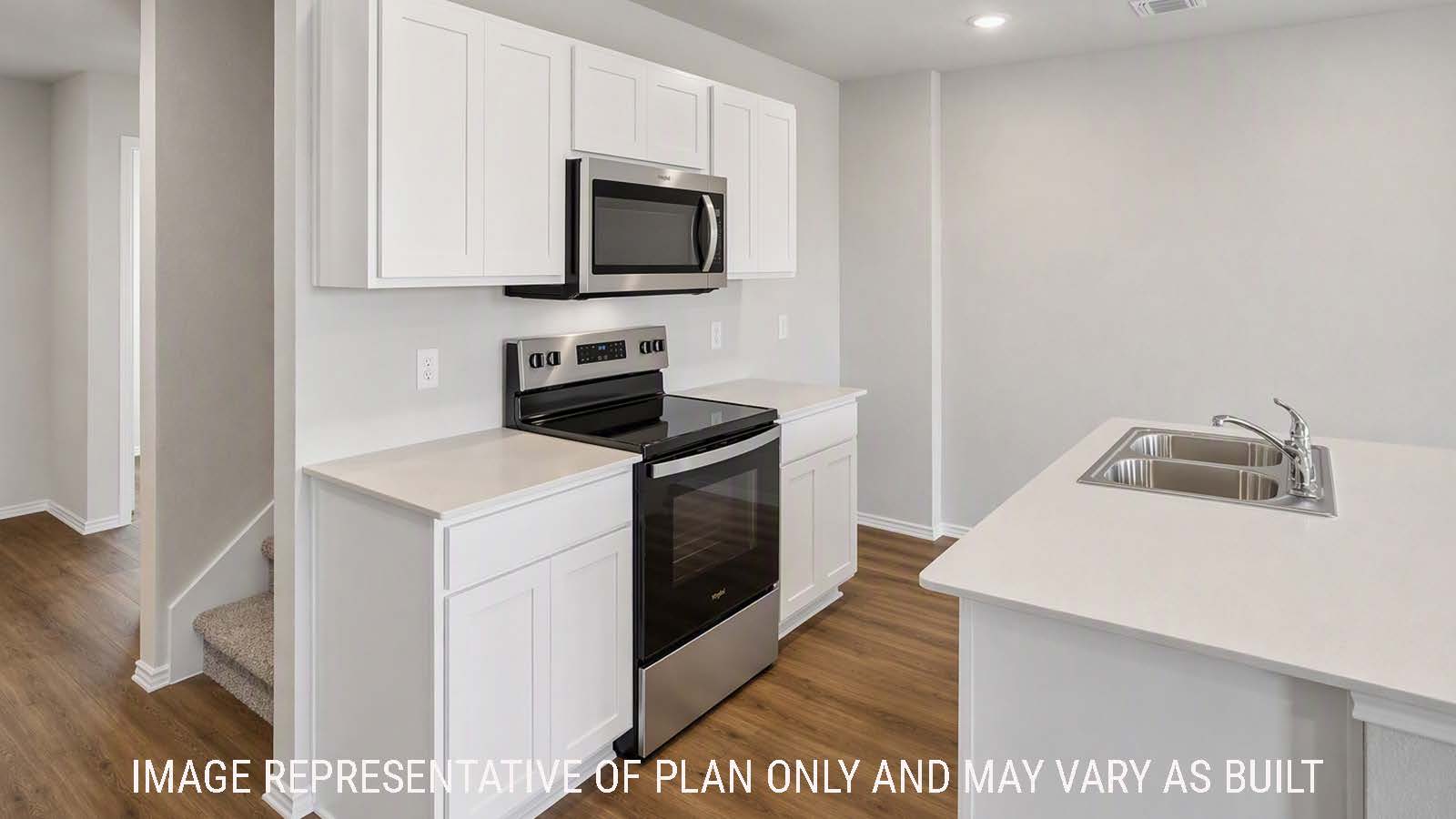 Denise kitchen with kitchen island with white cabinets and view of front entry hallway.