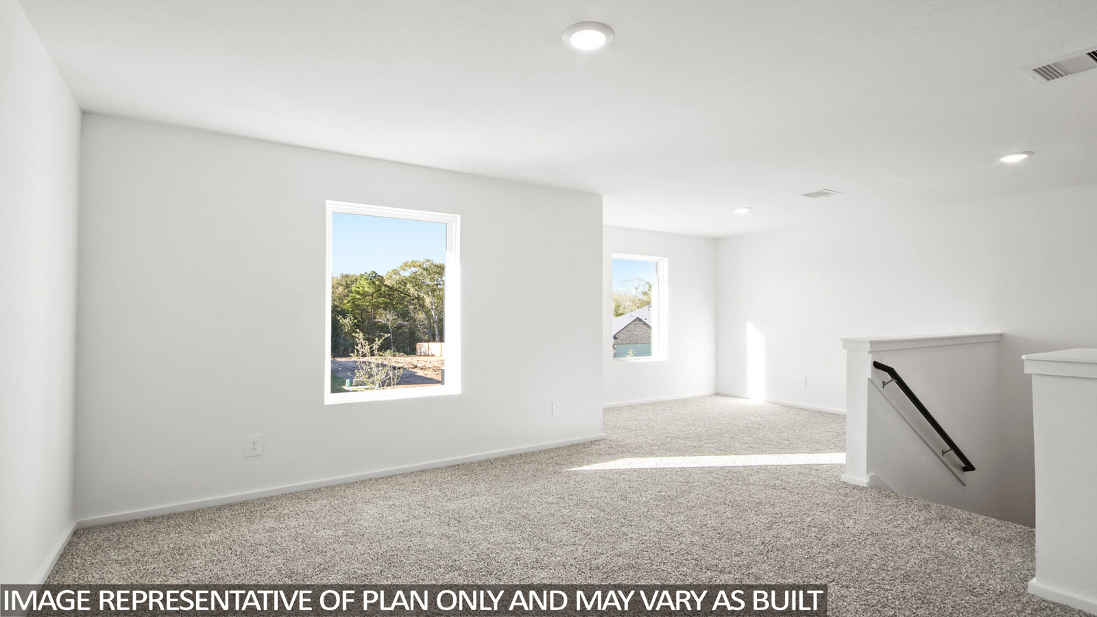 Denise game room with carpeted flooring and view of stairs and windows for natural lighting.