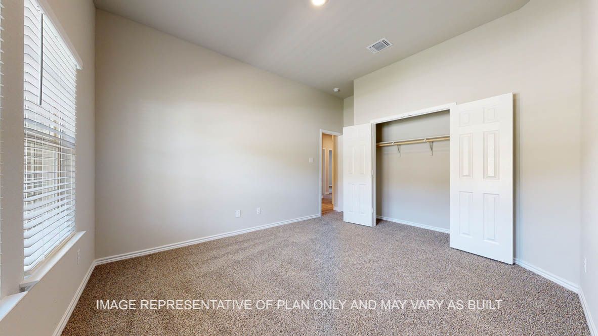 Elmwood secondary bedroom with carpet flooring and closet.