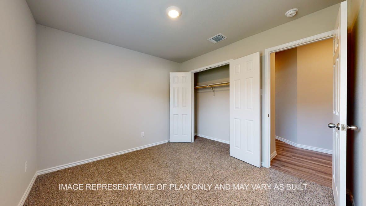 Elmwood secondary bedroom with carpet flooring and closet.