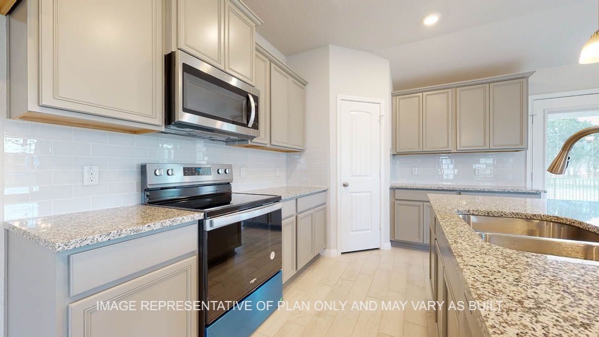 Elmwood kitchen with granite countertops and white cabinets.