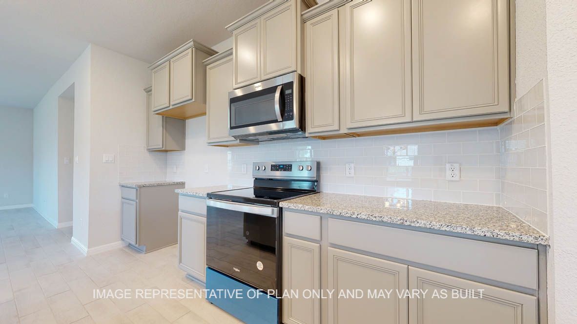 Elmwood kitchen with cabinets and stainless appliances.