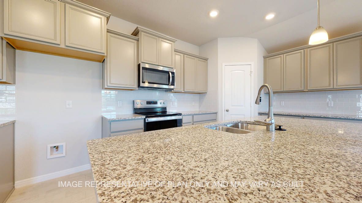 Elmwood kitchen with larger center island and undermount sink.
