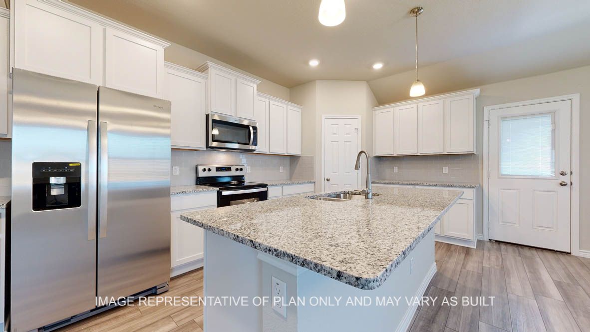 Elmwood kitchen with granite countertops and white cabinets.
