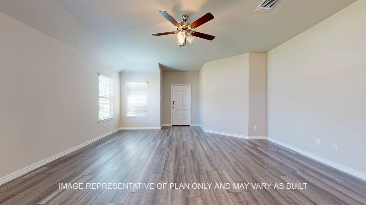 Elmwood entry and living room with vinyl plank flooring.