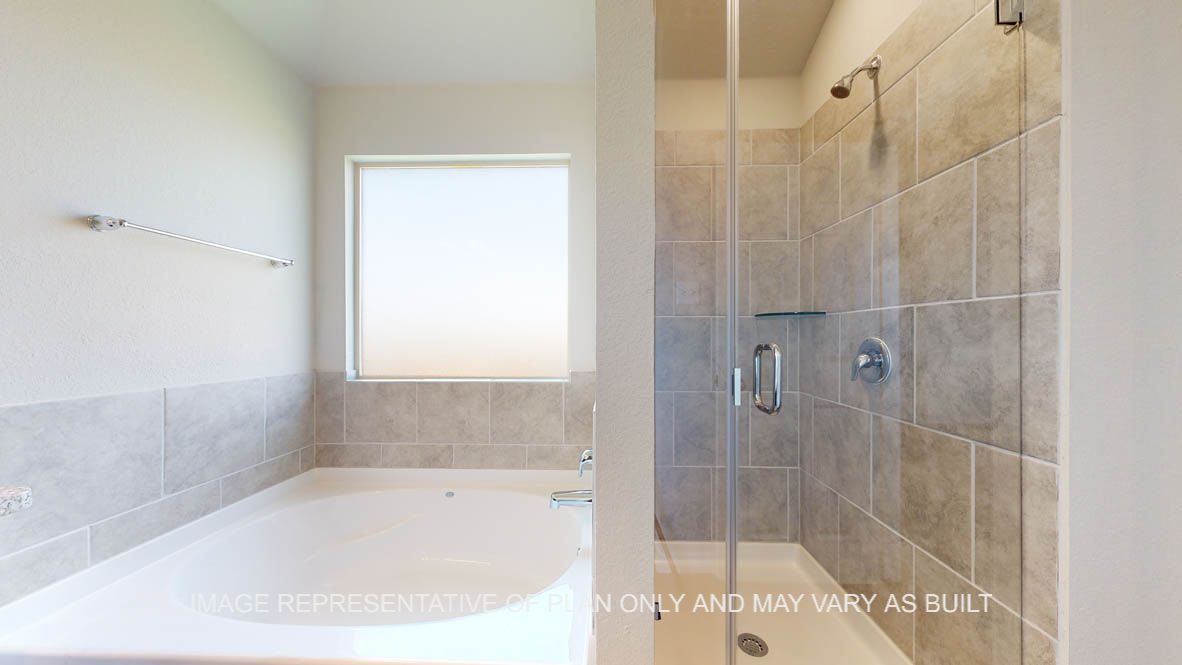 Elmwood primary bathroom with clear shower glass enclosure and garden tub.