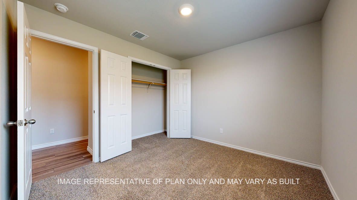 Elmwood secondary bedroom with carpet flooring and closet.