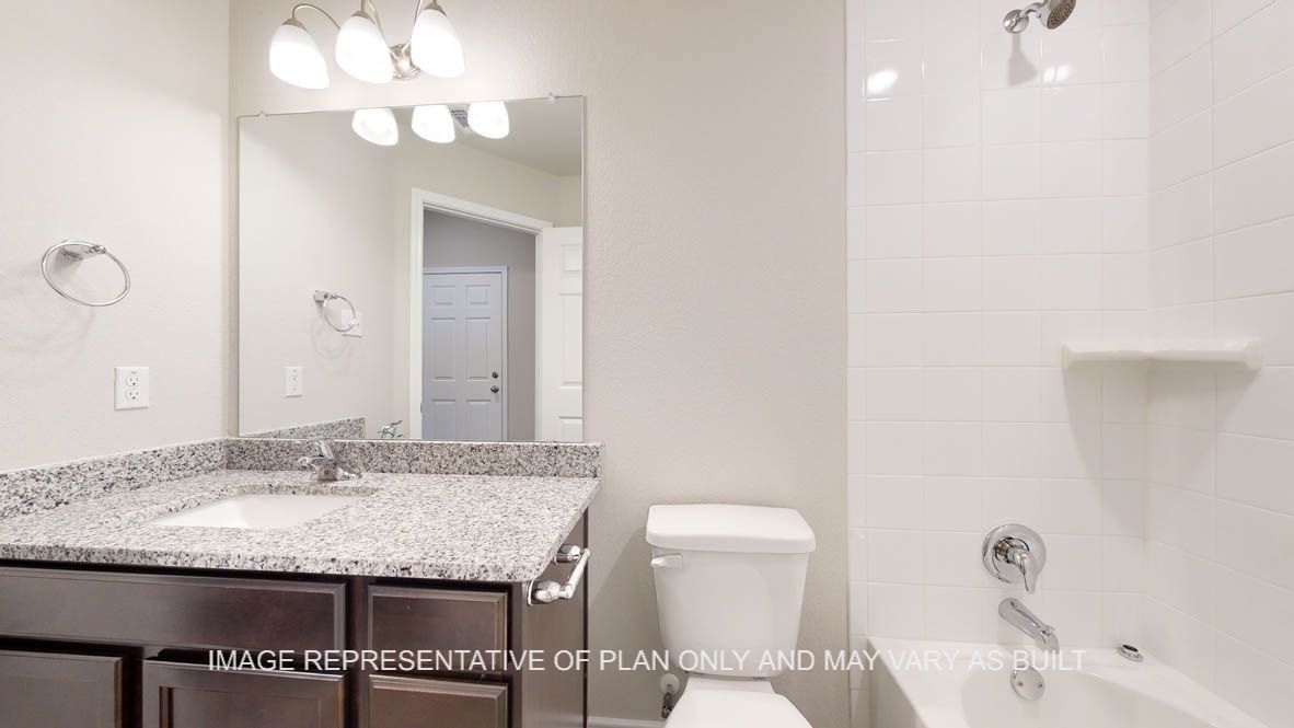 Elmwood secondary bathroom with single vanity and granite countertops.