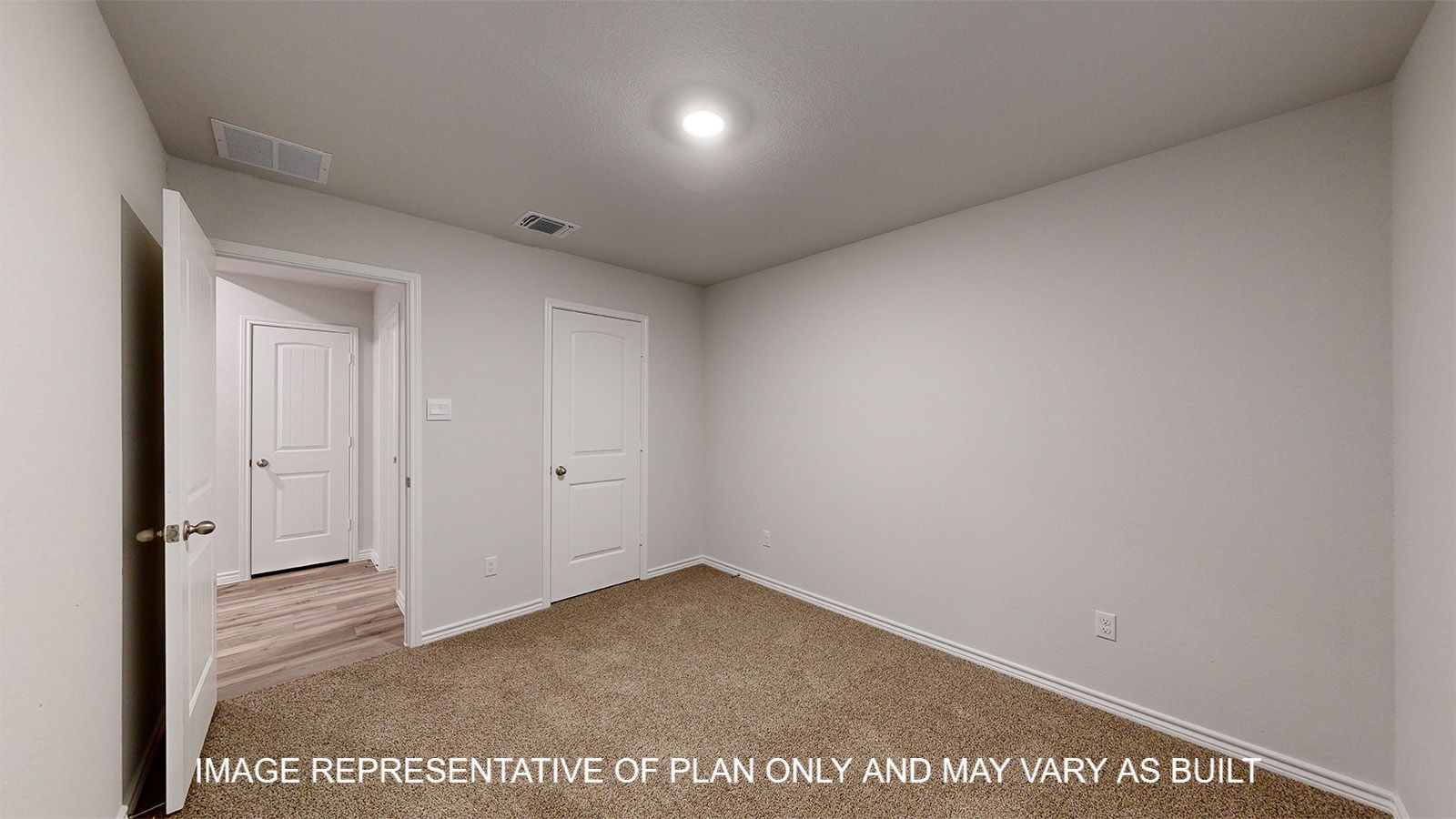 Everett secondary bedroom with carpet flooring and closet door.