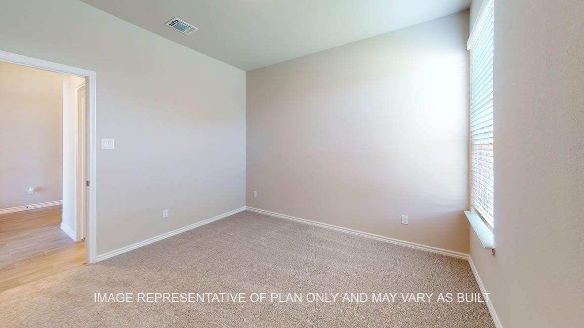 Sierra secondary bedroom with carpet flooring and walk-in closet.