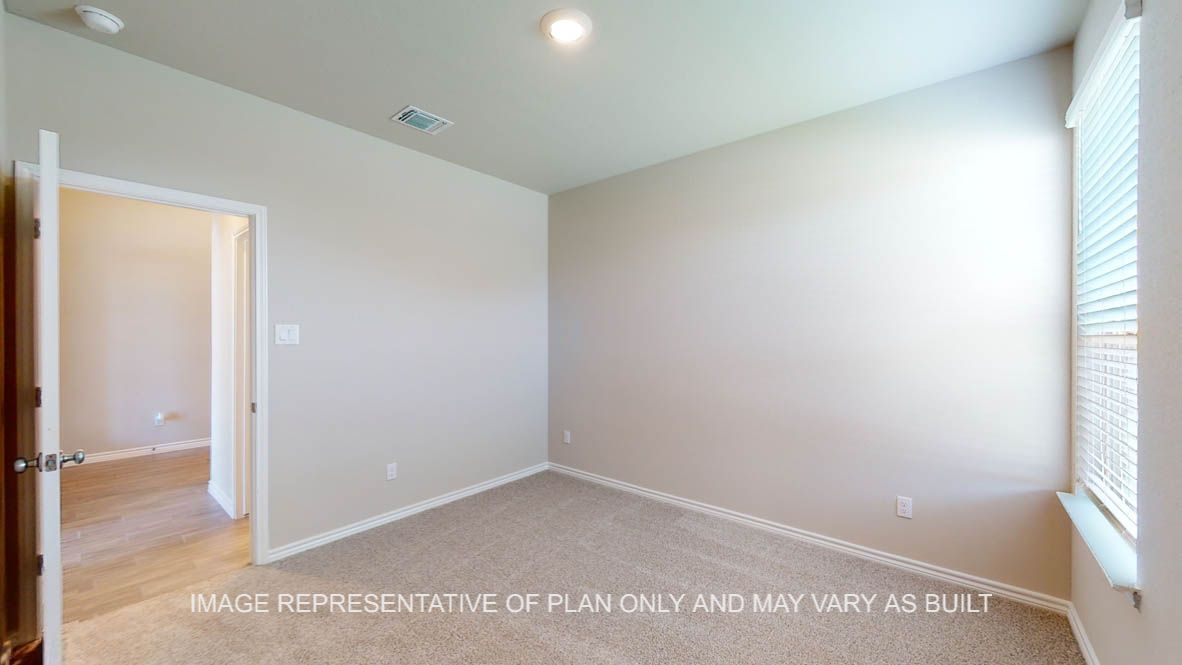 Sierra secondary bedroom with carpet flooring and window.