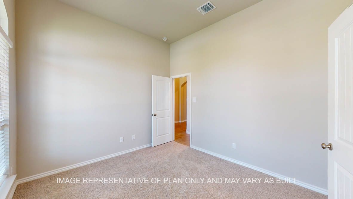 Sierra secondary bedroom with carpet flooring and walk-in closet.