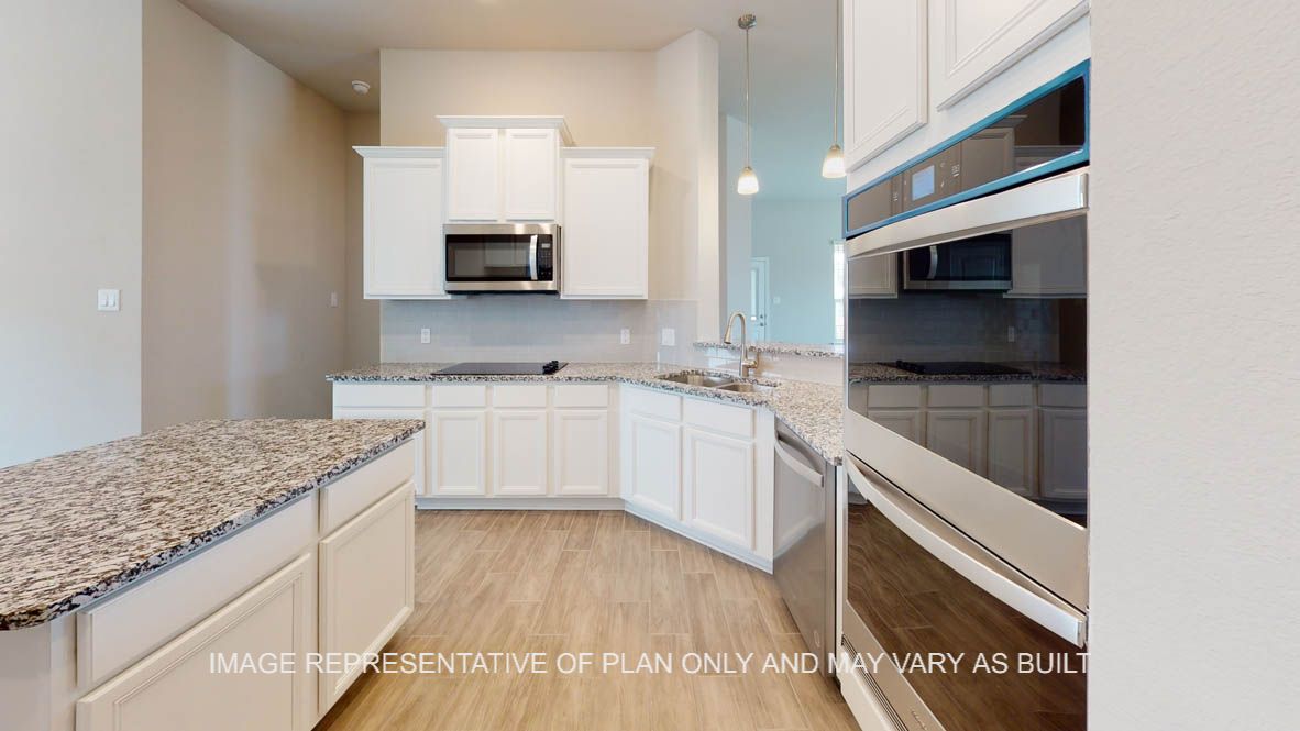 Sierra kitchen with wood look ceramic tile and stainless built-in double ovens.