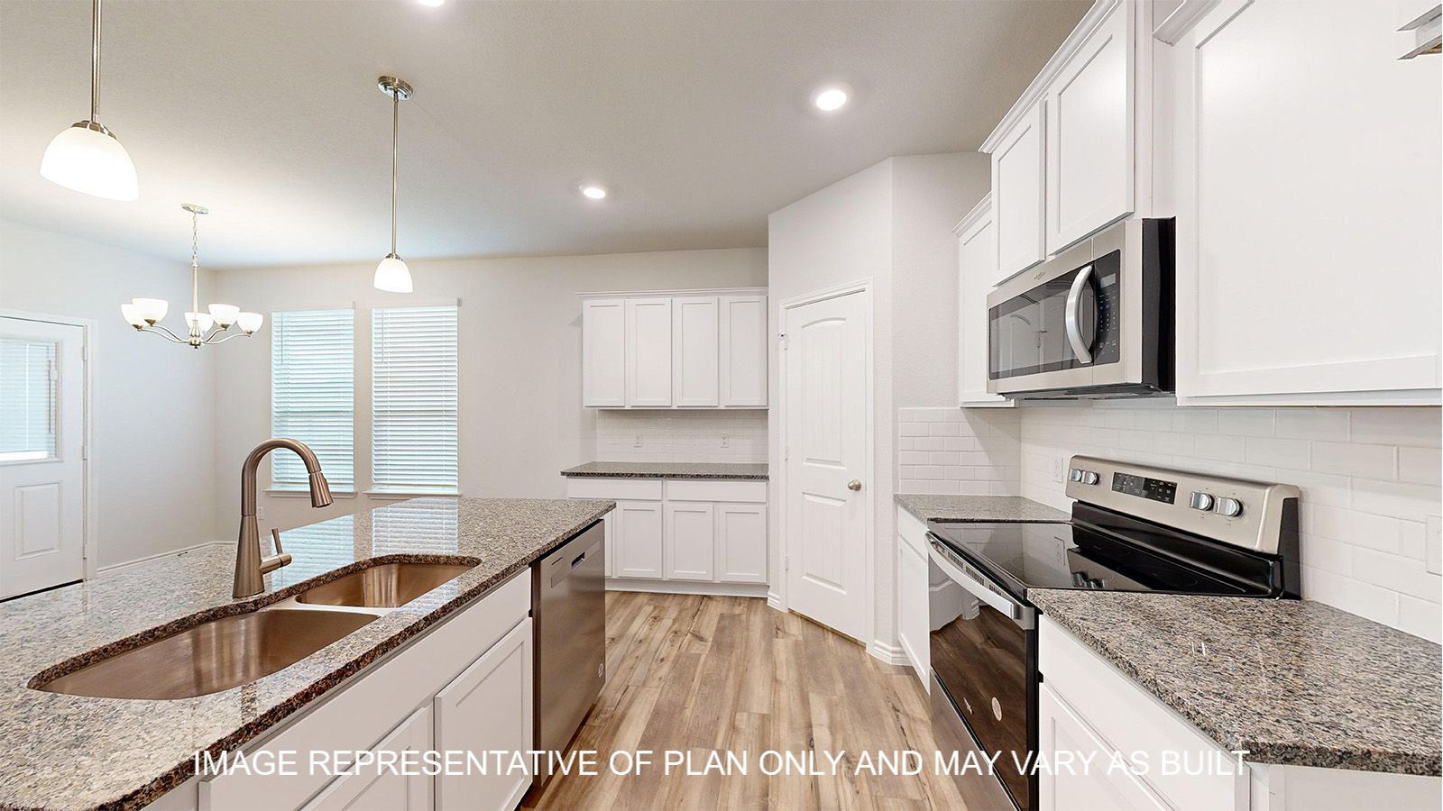Magnolia kitchen with white cabinets and vinyl plank flooring.