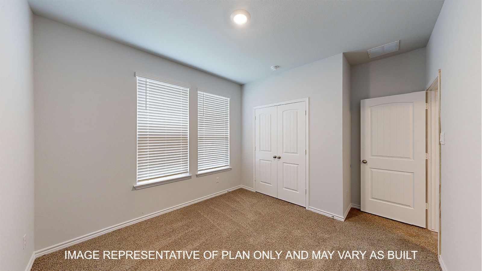 Magnolia secondary bedroom with carpet flooring and window.