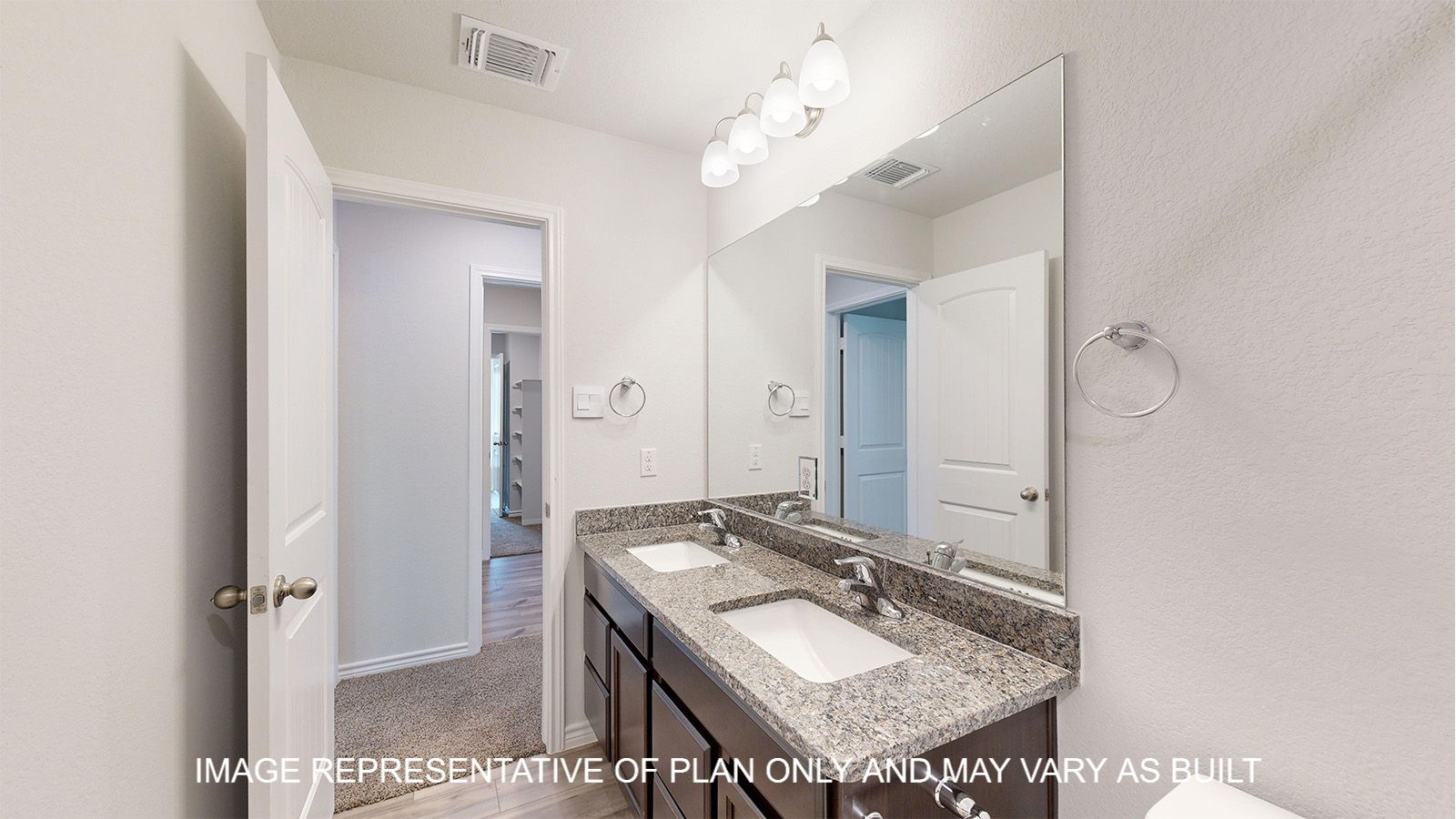 Magnolia secondary bathroom with dual vanities and granite countertops.