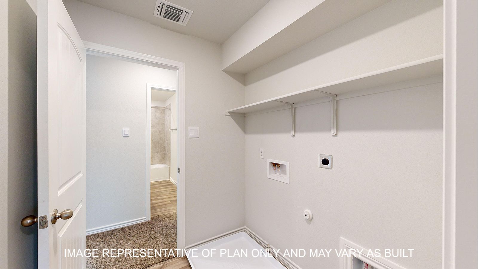 Magnolia utility room with storage shelf and vinyl plank flooring.