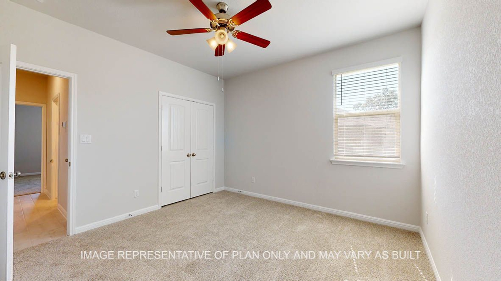 Parker secondary bedroom with carpet flooring and windows.