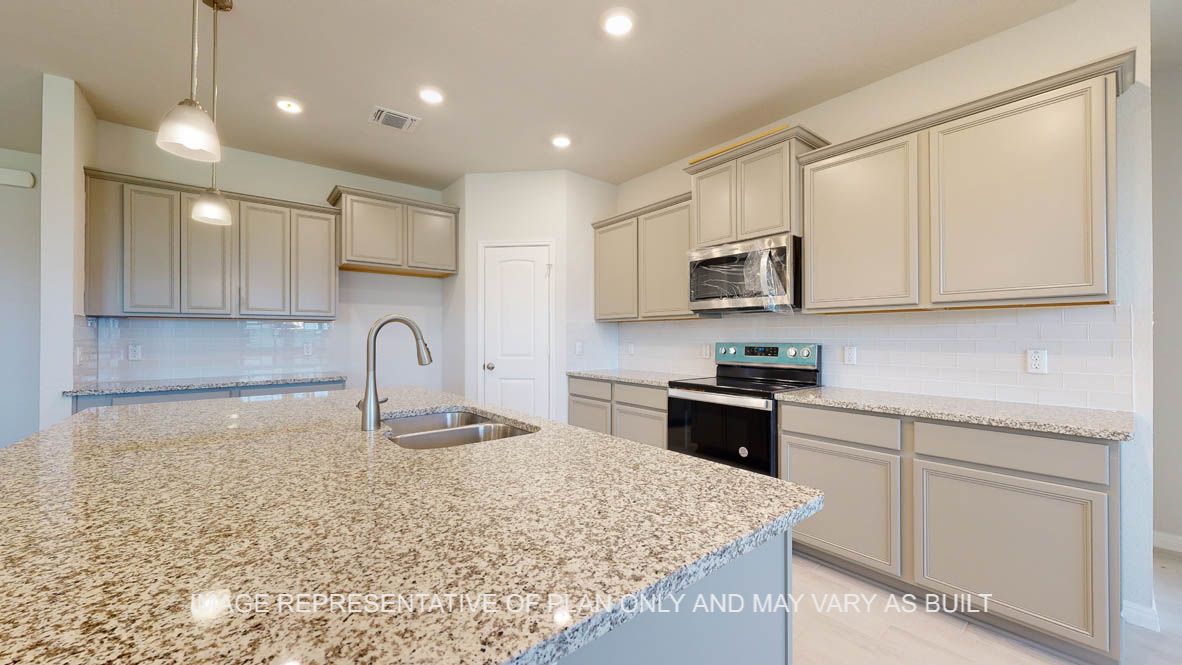 Parker kitchen with light griege painted cabinets, granite countertops and glass subway backsplash.