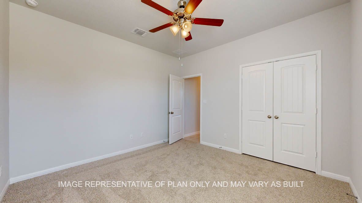 Parker secondary bedroom with carpet flooring and windows.