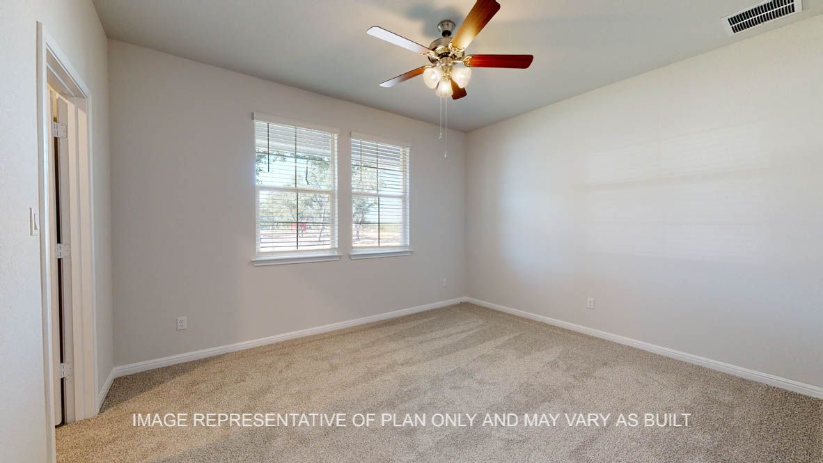 Parker secondary bedroom with carpet flooring and windows.