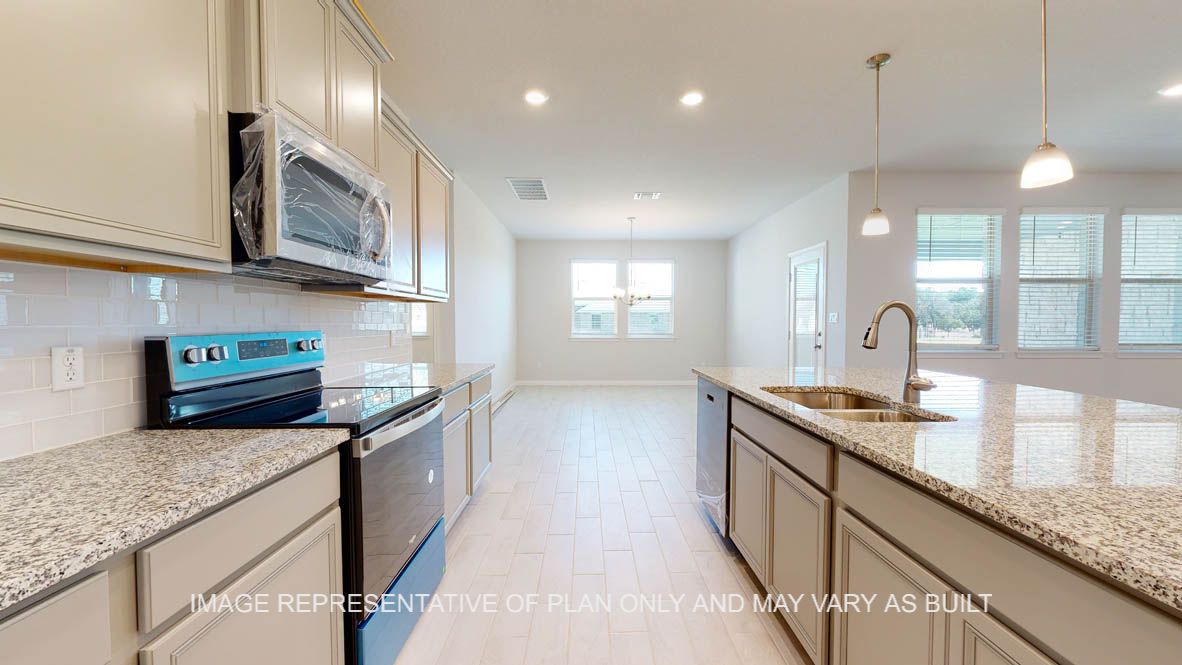 Parker kitchen with light griege painted cabinets, granite countertops and glass subway backsplash.