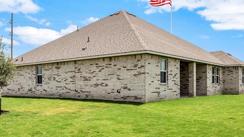 Country Meadows model home backyard with view of the back entry.