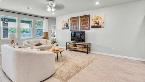Country Meadows model home living room with view of the secondary bedroom.