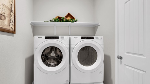 Country Meadows model home utility room with washer and dryer.