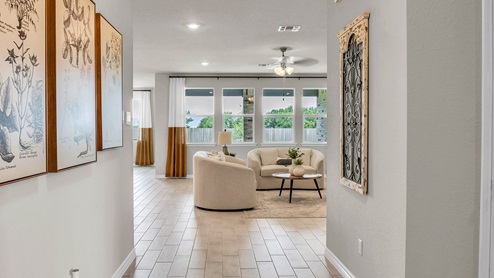 Country Meadows model home entry with wood look tile and decorations..