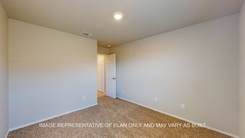 Texas Cali primary bedroom with carpet flooring.