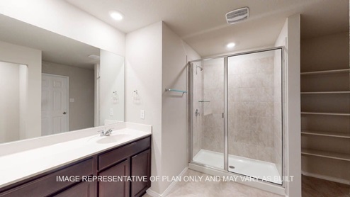 Texas Cali primary bath with shower with clear glass and tile surround.