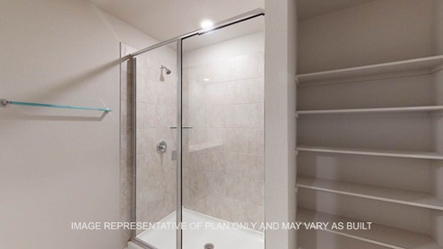 Texas Cali primary bath with shower with clear glass and tile surround.