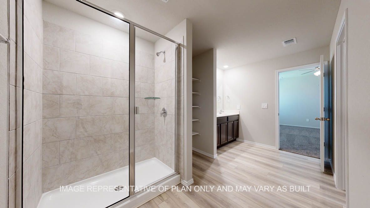 Seabrook primary bathroom with clear shower glass enclosure and ceramic tile surround at walk-in shower.