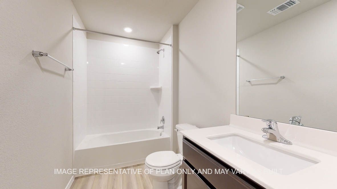 Seabrook secondary bath with dark cabinets and white countertops.